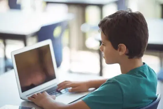 schoolboy using laptop in classroom 2023 11 27 05 36 18 utc scaled e1770043341435
